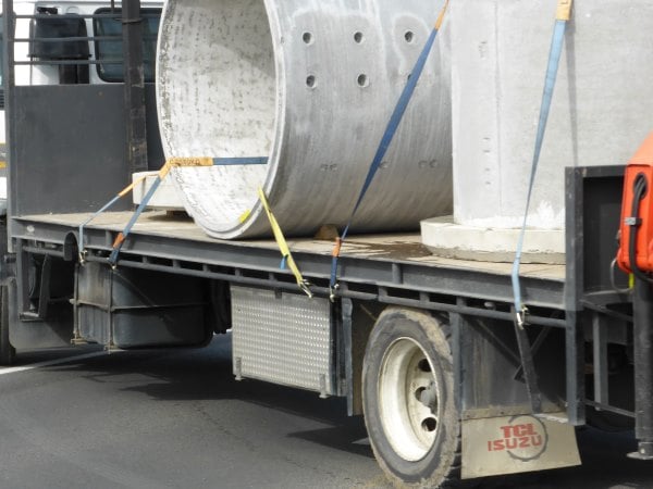 lashings on a truck carrying concrete pipes