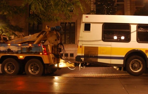 Heavy tow truck picks up the back of a large van