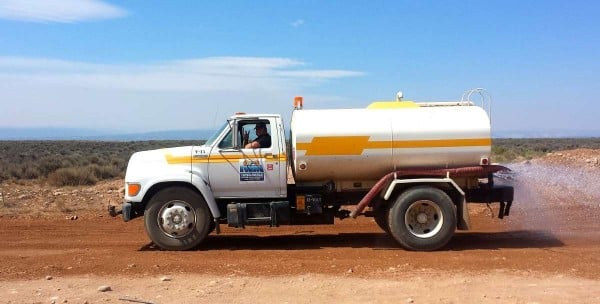 Small water tanker trucks are used to keep dust down on building sites and road works