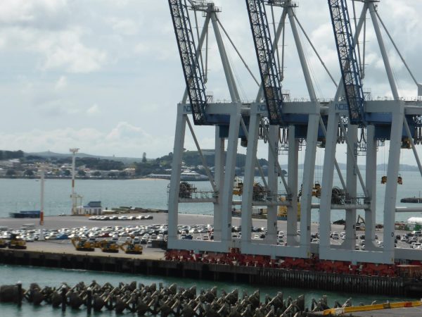 Behind the cranes, imported cars can be seen on the Bledisloe Container terminal