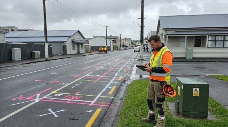 Permit issuer checks a stormwater pipe site with adjacent electrical hazard